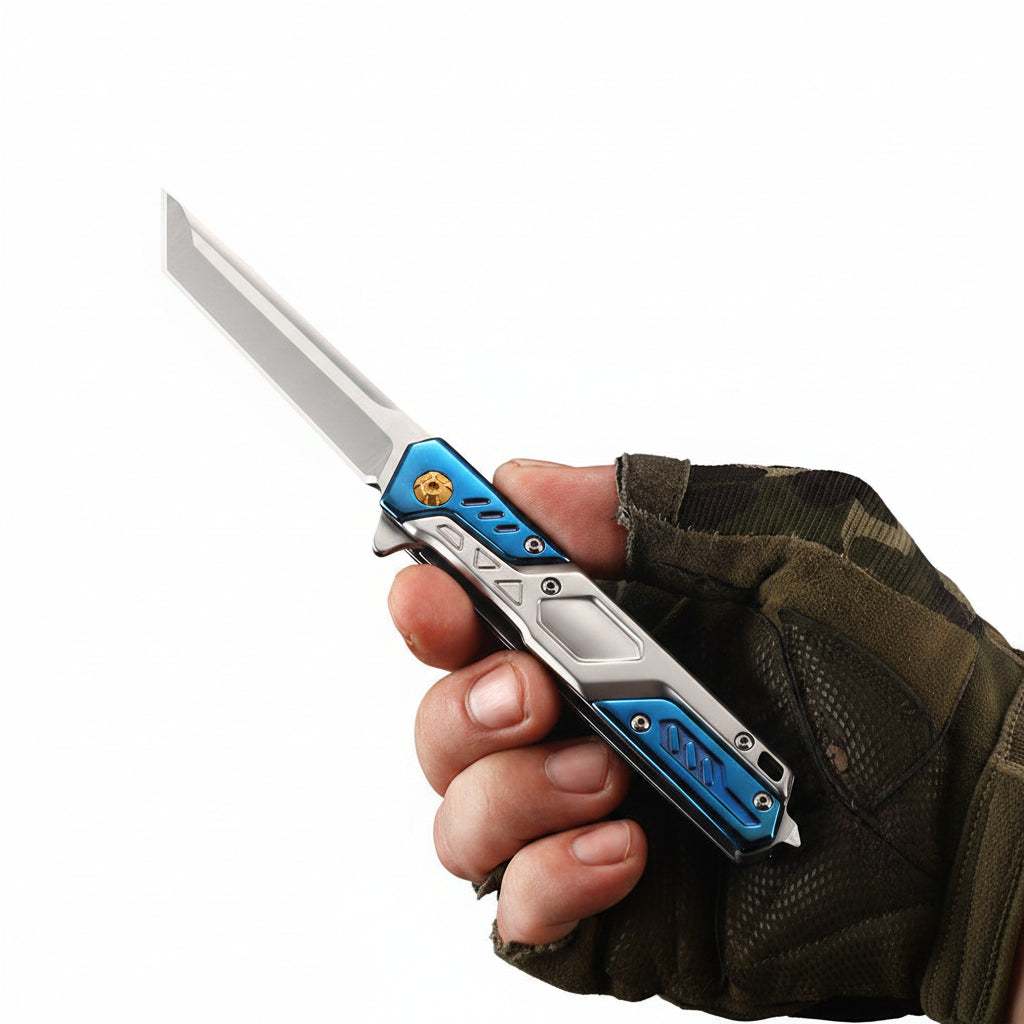 A tactical folding pocket knife with a silver blade and blue textured handle scales, held in a hand wearing a camouflage glove. The image features Chinese text '戚联虚倴' (comfortable grip) in white with a black outline at the top right, set against a dark gray gradient background.