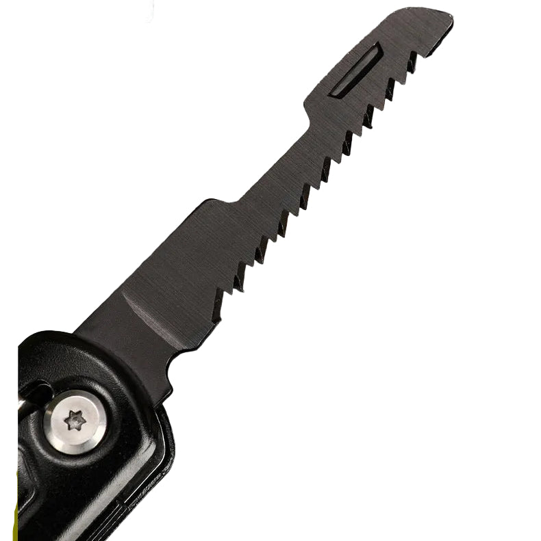 Close-up of a black folding knife blade with a saw-tooth edge, shown against a branch with green leaves. A Chinese text label is visible in the top left corner.