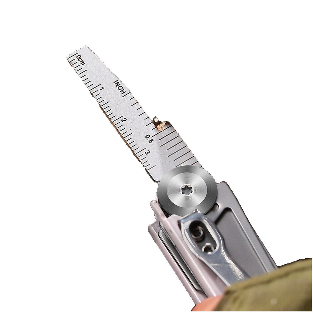 A silver folding utility knife with its blade extended to show a built-in ruler scale, photographed on a plain white background.